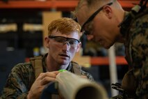 U.S. Marines remove munition from a simulated launcher during the annual East Coast EOD Team of the Year Competition on Marine Corps Base Camp Lejeune, North Carolina, July 23.