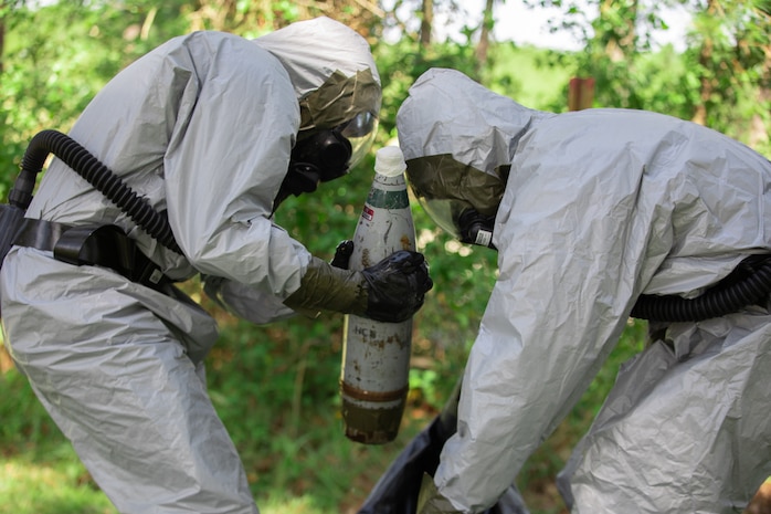 U.S. Marines place a decontaminated simulated chemical ordnance device in a secure container during the annual East Coast EOD Team of the Year Competition on Marine Corps Base Camp Lejeune, North Carolina, July 20 – 25.