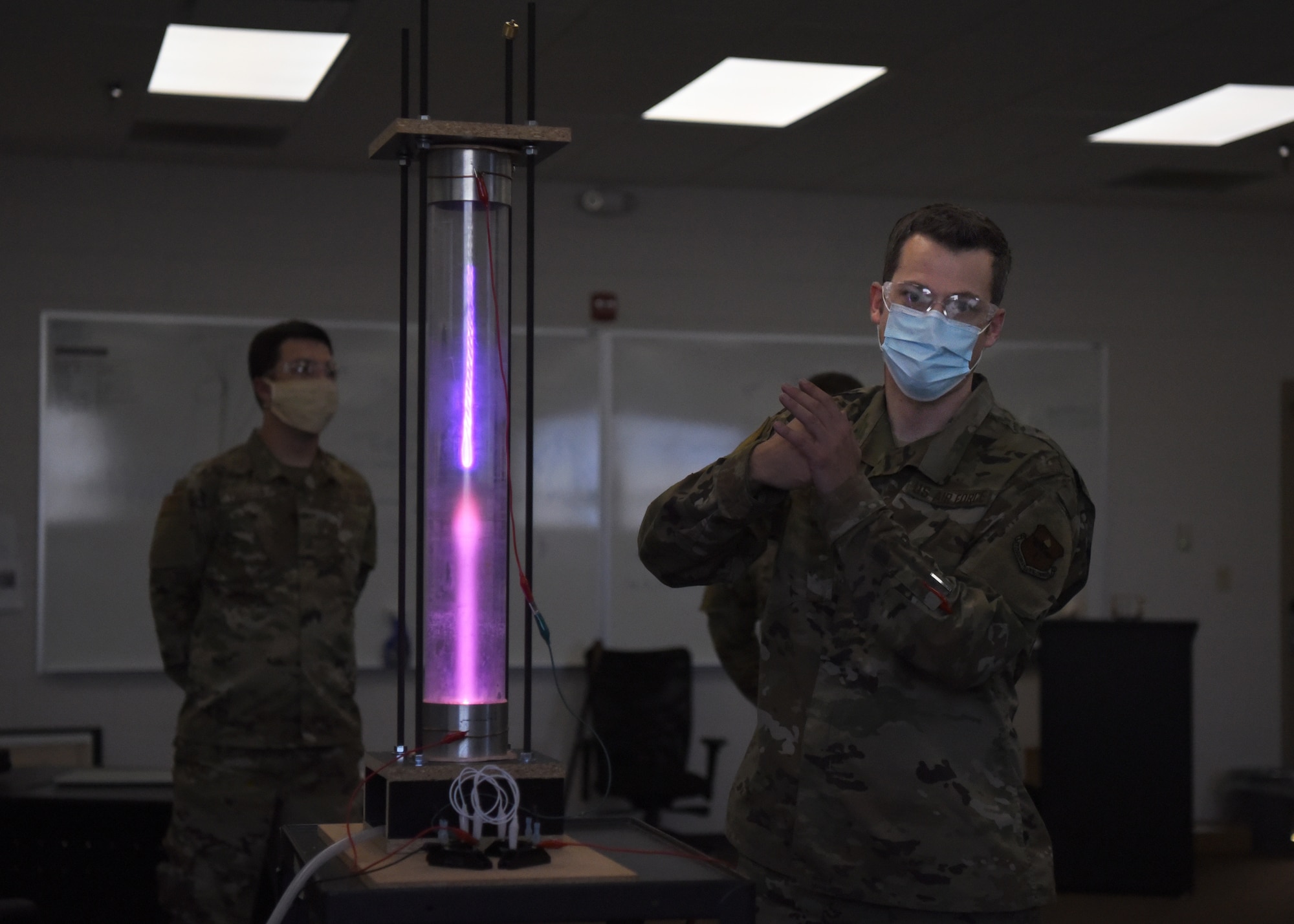 U.S. Air Force Tech. Sgt. David Hunt, 312th Training Squadron Special Instruments Training course instructor, explains different scientific concepts with a student-built plasma chamber, at the Louis F. Garland Department of Defense Fire Academy on Goodfellow Air Force Base, Texas, Aug. 5, 2020. Hunter demonstrated to the SPINSTRA students how volumetric pressure may affect electrons’ flow. (U.S. Air Force photo by Airman 1st Class Abbey Rieves)