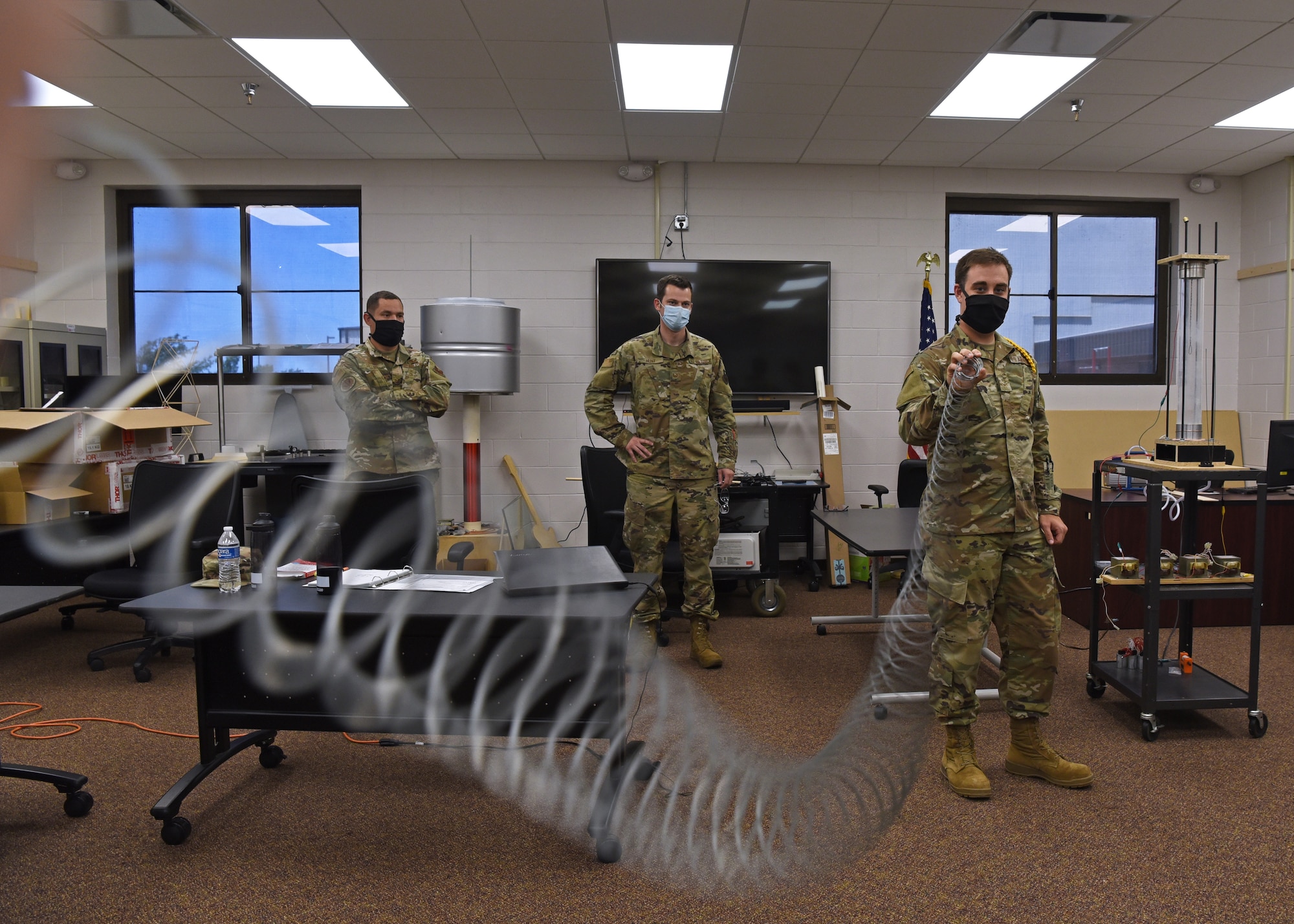 U.S. Air Force Airman 1st Class Kevin Page, 312th Training Squadron Special Instruments Training course student, learns about sound wave mechanics by using a coil-like prop for hands-on educational advances, inside the Louis F. Garland Department of Defense Fire Academy on Goodfellow Air Force Base, Texas, Aug. 5, 2020.  Props were used in the SPINSTRA learning environment to demonstrate larger-than-life concepts, which aided the students who learned visually. (U.S. Air Force photo by Airman 1st Class Abbey Rieves)