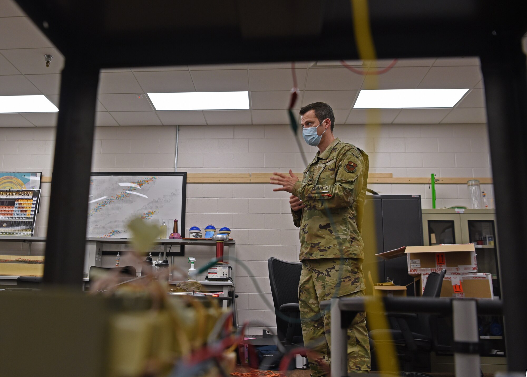 U.S. Air Force Tech. Sgt. David Hunt, 312th Training Squadron Special Instruments Training course instructor, answers questions from SPINSTRA students, while wearing a mask, inside the Louis F. Garland Department of Defense Fire Academy on Goodfellow Air Force Base, Texas, Aug. 5, 2020.  The SPINSTRA students followed COVID-19 safety precautions throughout their Air Force training, all-the-while learning mathematics, electronic principles, applied sciences, computer and network fundamentals, phenomenology, and  Intelligence, Surveillance, and Reconnaissance fundamentals. (U.S. Air Force photo by Airman 1st Class Abbey Rieves)