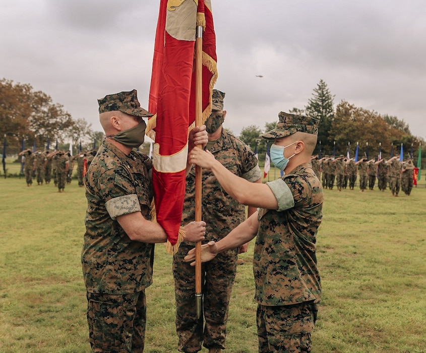 .LtCol. Ian M. Prater, the incoming Battalion Commander for 6th Communication Battalion, Force Headquarters Group, New York, left, accepts the battalion colors from LtCol. Henry H. Ko, Commander, 6th Communication Battalion, during a change of command ceremony at Curtin-Garvey Complex, Brooklyn, NY, Aug 8, 2020.
