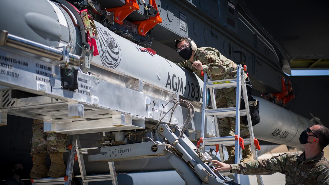 Staff Sgt. Jacob Puente, 912th Aircraft Maintenance Squadron, helps line up the AGM-183A Air-launched Rapid Response Weapon Instrumented Measurement Vehicle 2 as it is loaded under the wing of a B-52H Stratofortress at Edwards Air Force Base, California, Aug. 6. The ARRW IMV-2 successfully completed a captive carry test off the Southern California coast, Aug. 8. (Air Force photo by Giancarlo Casem)