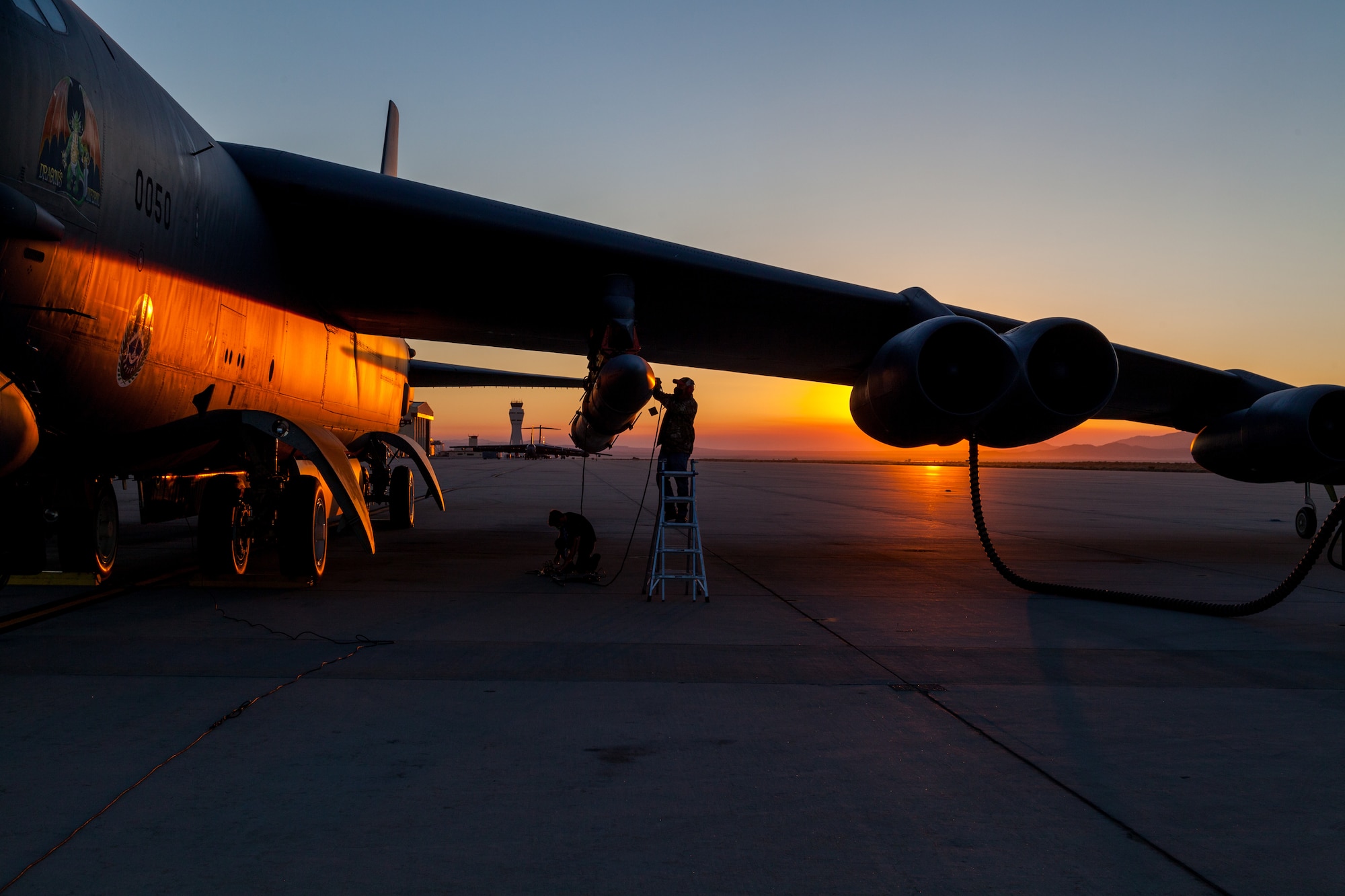 Members of the AGM-183A Air-launched Rapid Response Weapon Instrumented Measurement Vehicle 2 test team make final preparations prior to a captive-carry test flight of the prototype hypersonic weapon at Edwards Air Force Base, California, Aug. 8. (Air Force photo by Kyle Brasier)