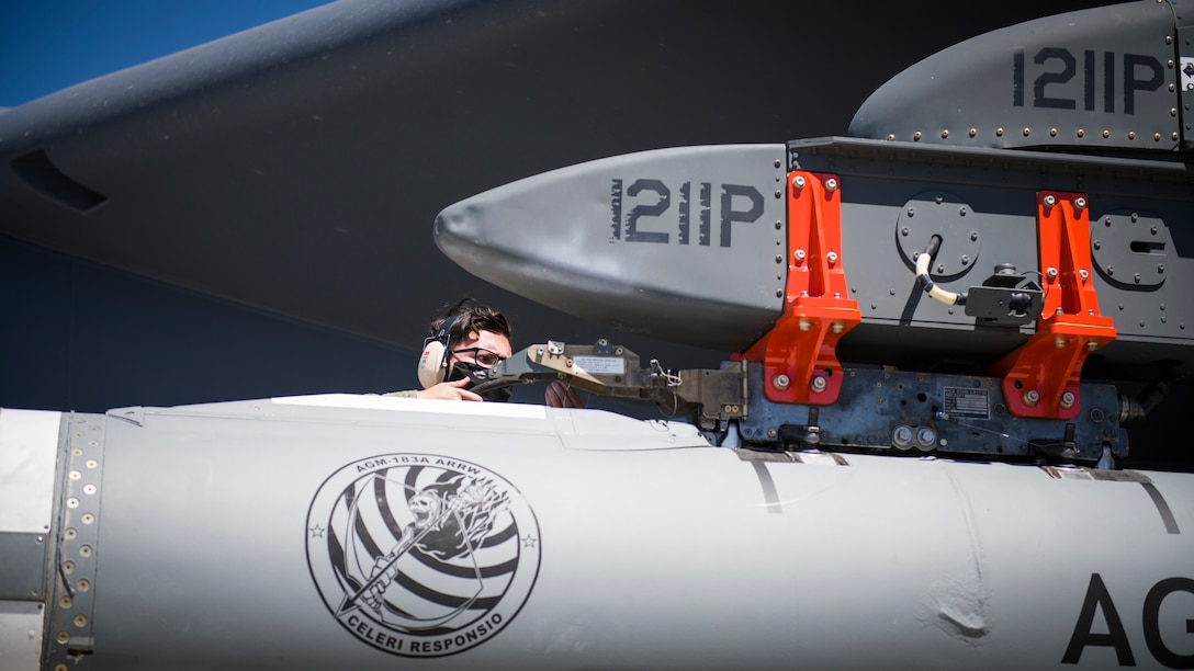 Staff Sgt. Jacob Puente, 912th Aircraft Maintenance Squadron, secures the AGM-183A Air-launched Rapid Response Weapon Instrumented Measurement Vehicle 2 as it is loaded under the wing of a B-52H Stratofortress at Edwards Air Force Base, California, Aug. 6. The ARRW IMV-2 successfully completed a captive carry test off the Southern California coast, Aug. 8. (Air Force photo by Giancarlo Casem)