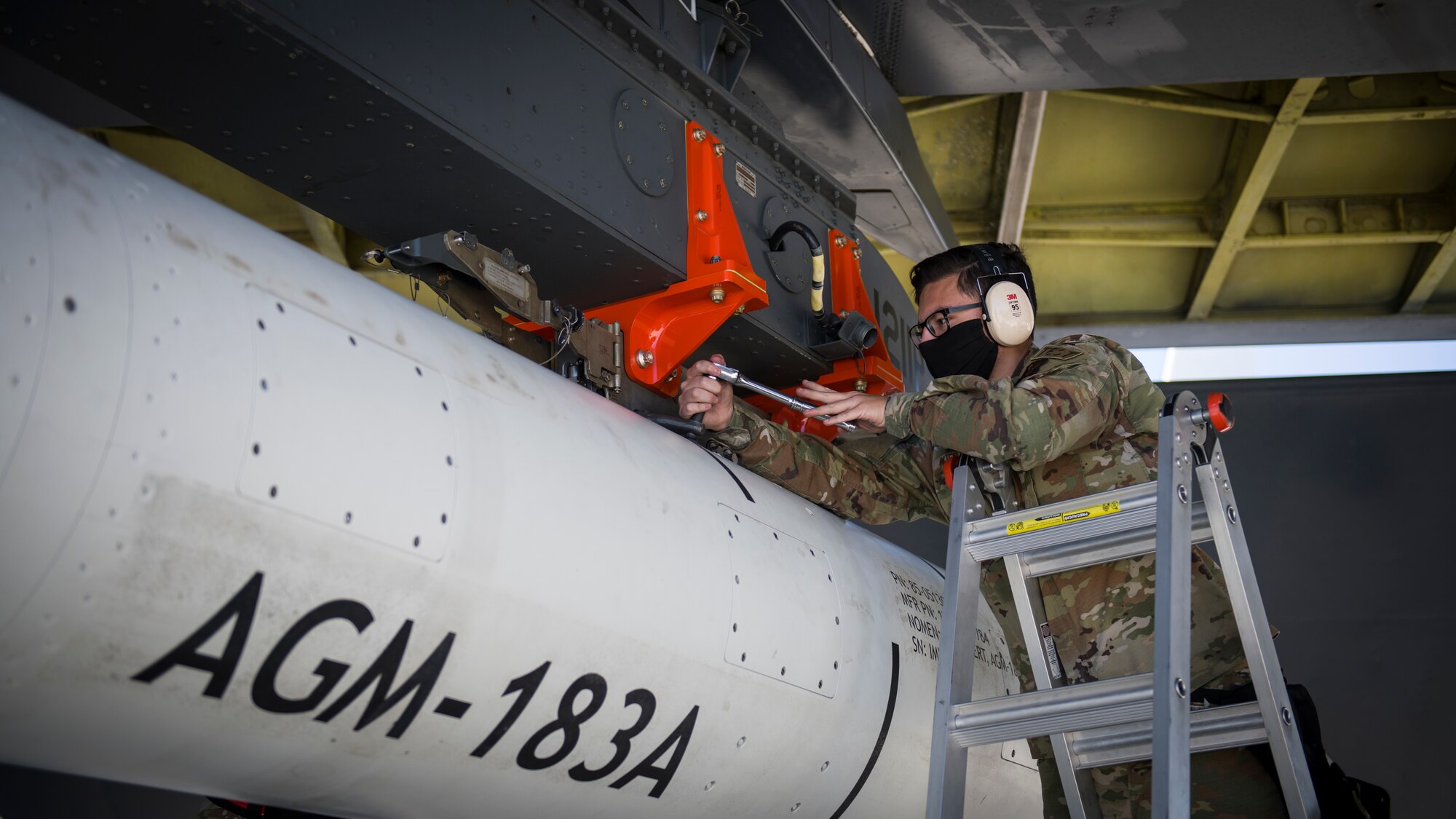 Staff Sgt. Jacob Puente, 912th Aircraft Maintenance Squadron, secures the AGM-183A Air-launched Rapid Response Weapon Instrumented Measurement Vehicle 1 as it is loaded under the wing of a B-52H Stratofortress at Edwards Air Force Base, California, Aug. 6. The ARRW IMV-2 successfully completed a captive carry test off the Southern California coast, Aug. 8. (Air Force photo by Giancarlo Casem)