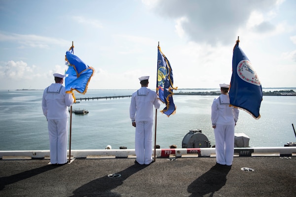 Sailors man the rails as the Nimitz-class aircraft carrier USS Dwight D. Eisenhower (CVN 69) returns to Naval Station Norfolk.