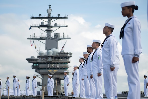 Sailors man the rails as the Nimitz-class aircraft carrier USS Dwight D. Eisenhower (CVN 69) returns to Naval Station Norfolk.