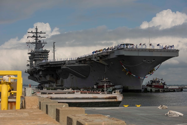Sailors assigned to USS Dwight D. Eisenhower (CVN 69) man the rails as the ship returns to Naval Station Norfolk.