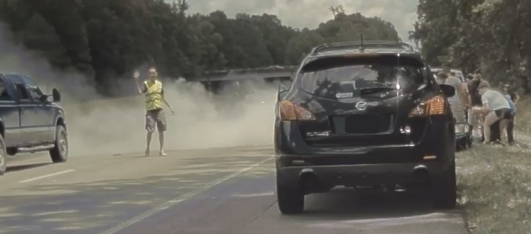 Office of Special Investigations Special Agent Robert Davis directs traffic safely around the accident on Interstate 64, near Quinton, Va., Aug. 4, 2020. SA Davis and OSI's Ms. Lieve Cuypers rendered aid to multiple accident victims that day. (Courtesy photo)