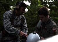 U.S. Air Force Tech. Sgt. Kevin Zamora, 35th Operation Support Squadron Survival, Evasion, Resistance and Escape specialist, teaches U.S. Navy Lt. j.g. Evan Jones, Electronic Attack Squadron (VAQ) 131 electronic warfare officer, about combat search and rescue during Exercise Forest Thunder 20 at Draughon Range near Misawa Air Base, Japan, Aug. 3, 2020. The training brought together Air Force and Navy personnel in an integrated operation, showcasing the joint force's ability to cooperate on complex multi-domain combat mission sets. (U.S Air Force photo by Staff Sgt. Grace Nichols)