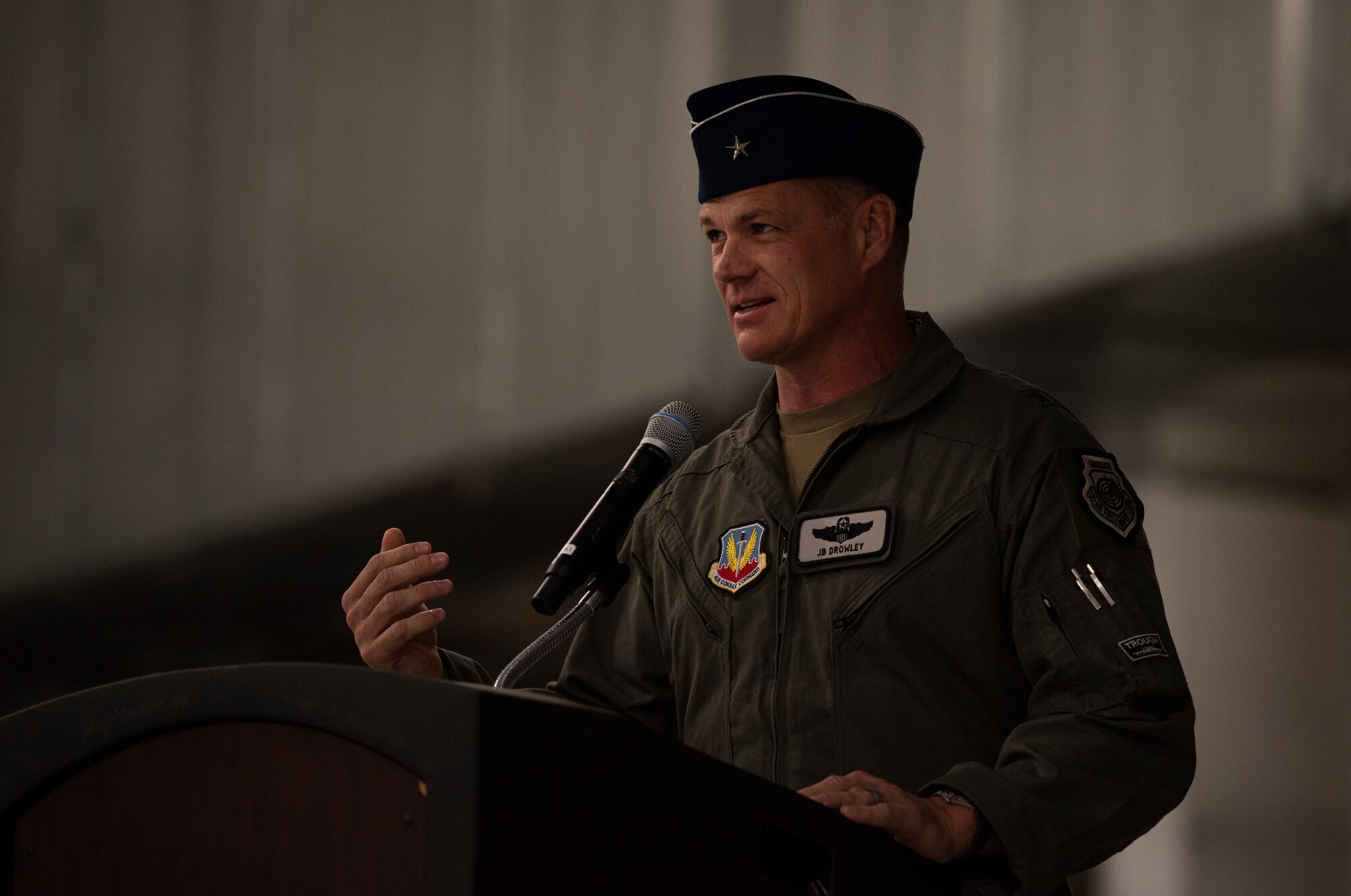 Brig. Gen. Michael Drowley stands at a podium and talks to the crowd during a ceremony.