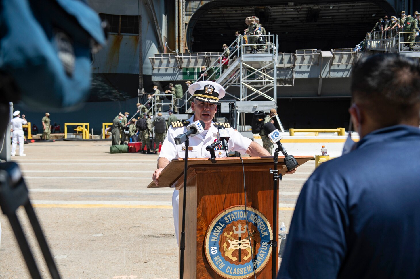 Capt. Kyle Higgins, commanding officer of the Nimitz-class aircraft carrier USS Dwight D. Eisenhower (CVN 69), speaks to the press after a regularly scheduled deployment.