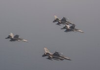 Two F-16 Fighting Falcons and two F/A-18E Super Hornets soar over the Northern Coast of Japan, Aug. 5, 2020.The U.S. Navy and Air Force conducted joint intergrated training off the coast of Northern Japan. Units and personnel assigned to the Ronald Reagan Carrier Strike Group, Navy Electronic Attack Squadron (VAQ) 131, and the Air Force 35th FIghter Wing began coordinated operations Aug. 1. (U.S. Air Force photo by Staff Sgt. Brittany A. Chase)