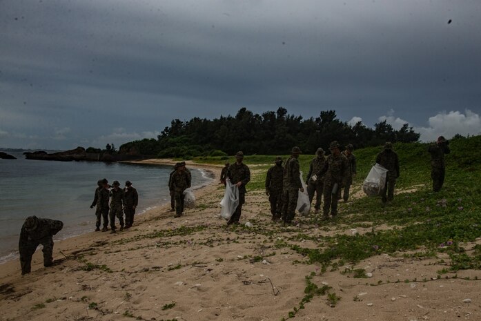 Marines with Combined Anti-Armor Team 1 (CAAT), Battalion Landing Team, 2nd Battalion, 4th Marines, 31st Marine Expeditionary Unit (MEU), clean the beach at Kin Blue, Okinawa, Japan, July 25, 2020. At the conclusion of their training, CAAT-1 picked up trash that had washed up on the beach in order to leave the environment better than they found it. The 31st MEU, the Marine Corps’ only continuously forward-deployed MEU, provides a flexible and lethal force ready to perform a wide range of military operations as the premier crisis response force in the Indo-Pacific region. The 31st MEU has implemented strict health protection measures and will continue to conduct mission essential training in support of regional security and stability. (U.S. Marine Corps photo by Lance Cpl. Kolby Leger)