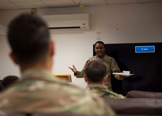 Chaplain officer speaking to group of soldiers