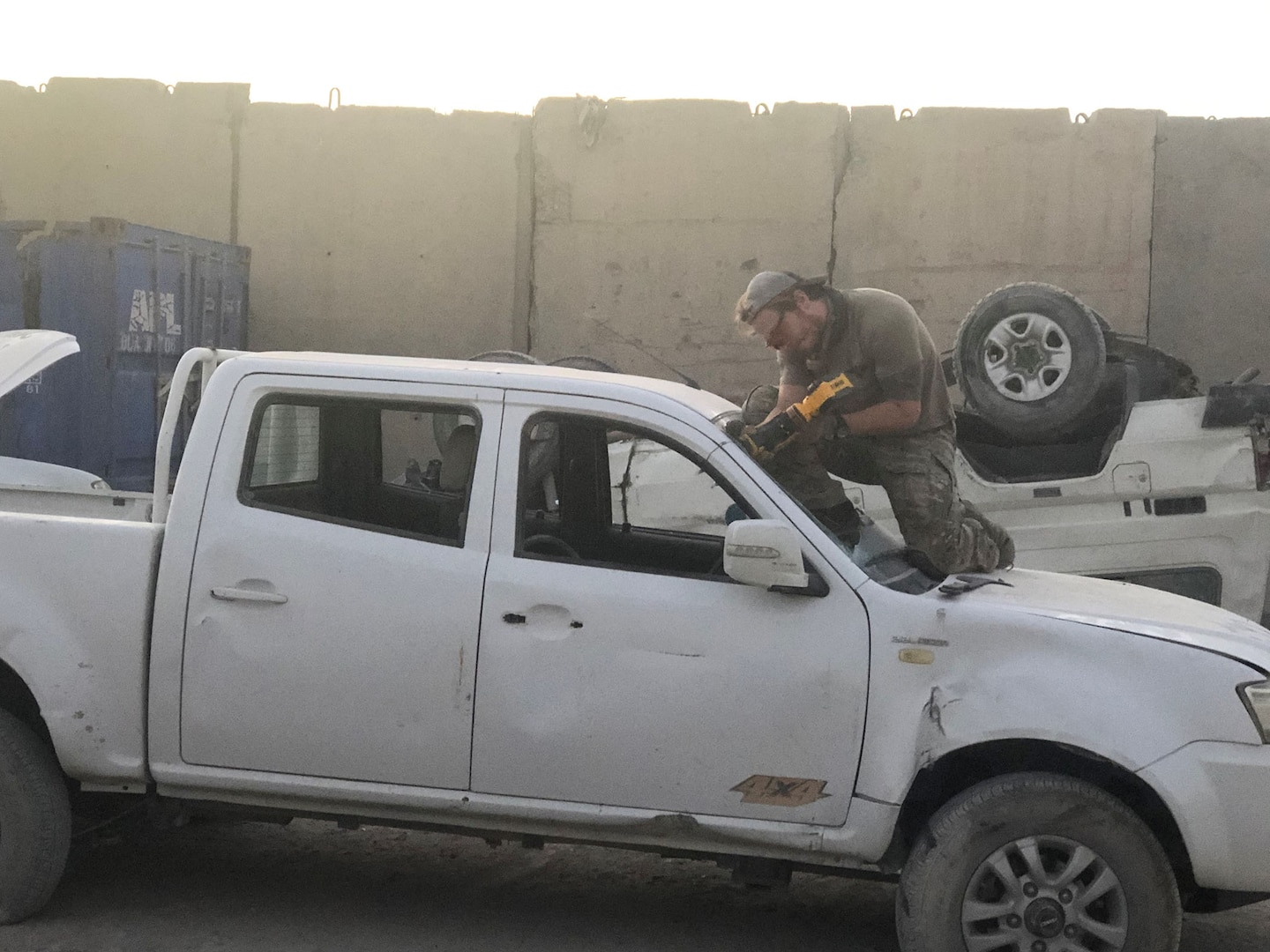 An airman from the Air Force’s 48th Rescue Squadron practices skills used to extricate vehicle occupants during a July 31 training session at the DLA Disposition Services yard at Kandahar, Afghanistan.