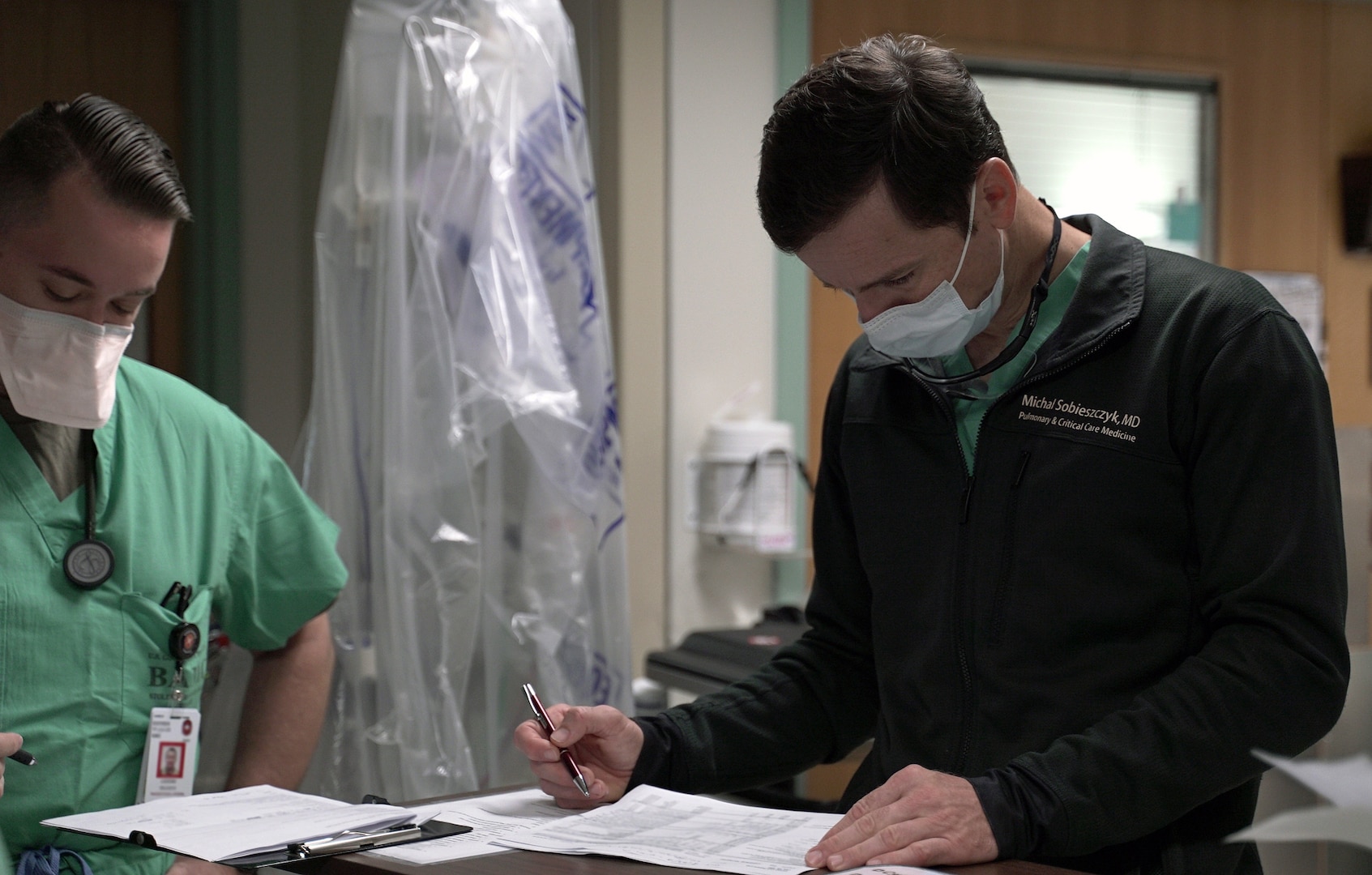 Army Maj. Michal Sobieszczyk, staff physician, Interventional Pulmonology and Critical Care Medicine, reviews paperwork in a COVID-19 intensive care unit at Brooke Army Medical Center, Joint Base San Antonio-Fort Sam Houston July 17.