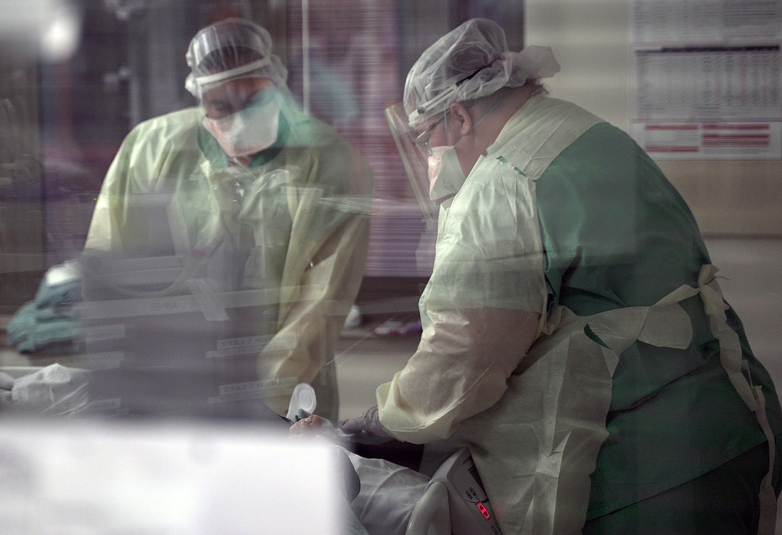 Nurses tend to a patient on extracorporeal membrane oxygenation, or ECMO, in a COVID-19 intensive care unit at Brooke Army Medical Center, Joint Base San Antonio-Fort Sam Houston, Texas, July 17, 2020.