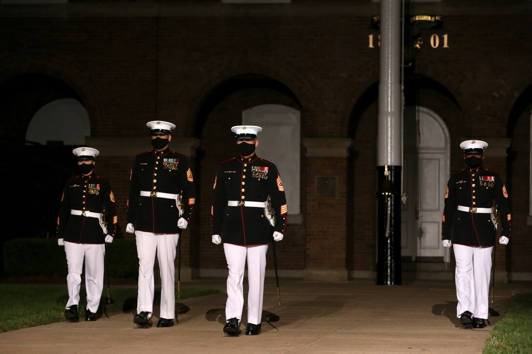 The Marine Barracks Washington, D.C. parade marching staff march down “Center Walk” during the Staff Noncommissioned Officer Friday Evening Parade at the Barracks, Aug. 7, 2020. The 19th Sergeant Major of the Marine Corps, Sgt. Maj. Troy E. Black, hosted the ceremony, and Senior Enlisted Advisor to the Chairman of the Joint Chiefs of Staff Ramón “CZ” Colón-López was the guest of honor. Barracks’ SNCOs fulfilled key leader’s billets throughout the ceremony that are normally performed by other Marines from throughout the battalion.