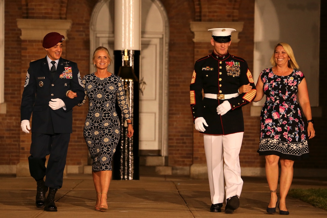 Sergeant Maj. Troy E. Black, 19th Sergeant Major of the Marine Corps, and Senior Enlisted Advisor to the Chairman of the Joint Chiefs of Staff, Ramón “CZ” Colón-López, march down center walk with their wives during the Staff Noncommissioned Officer Friday Evening Parade at Marine Barracks Washington, D.C., Aug. 7, 2020. Staff Noncommissioned Officers took charge and filled key leaders’ roles and billets throughout the parade. Sergeant Maj. Black was the hosting official and the guest of honor was Colón-López. (U.S. Marine Corps photo by Lance Cpl. Allen Sanders)