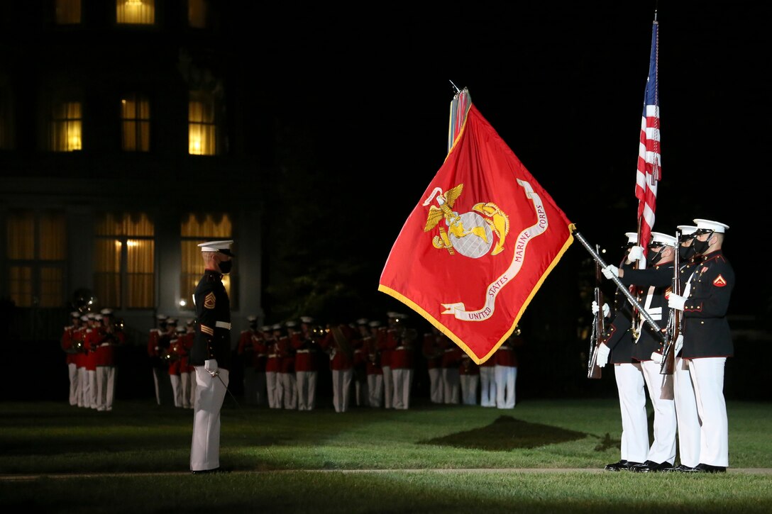 Marines with the Official U.S. Marine Corps Color Guard present the National Ensign  for the playing of our National Anthem during the Staff Noncommissioned Officer Friday Evening Parade at Marine Barracks Washington, D.C., Aug. 7, 2020. Staff Noncommissioned Officers took charge and filled key leaders’ roles and billets throughout the parade. The 19th Sergeant Major of the Marine Corps, Sgt. Maj. Troy E. Black, hosted last night’s ceremony, and the guest of honor was the Senior Enlisted Advisor to the Chairman of the Joint Chiefs of Staff, Ramón “CZ” Colón-López. (U.S. Marine Corps photo by Lance Cpl. Allen Sanders)