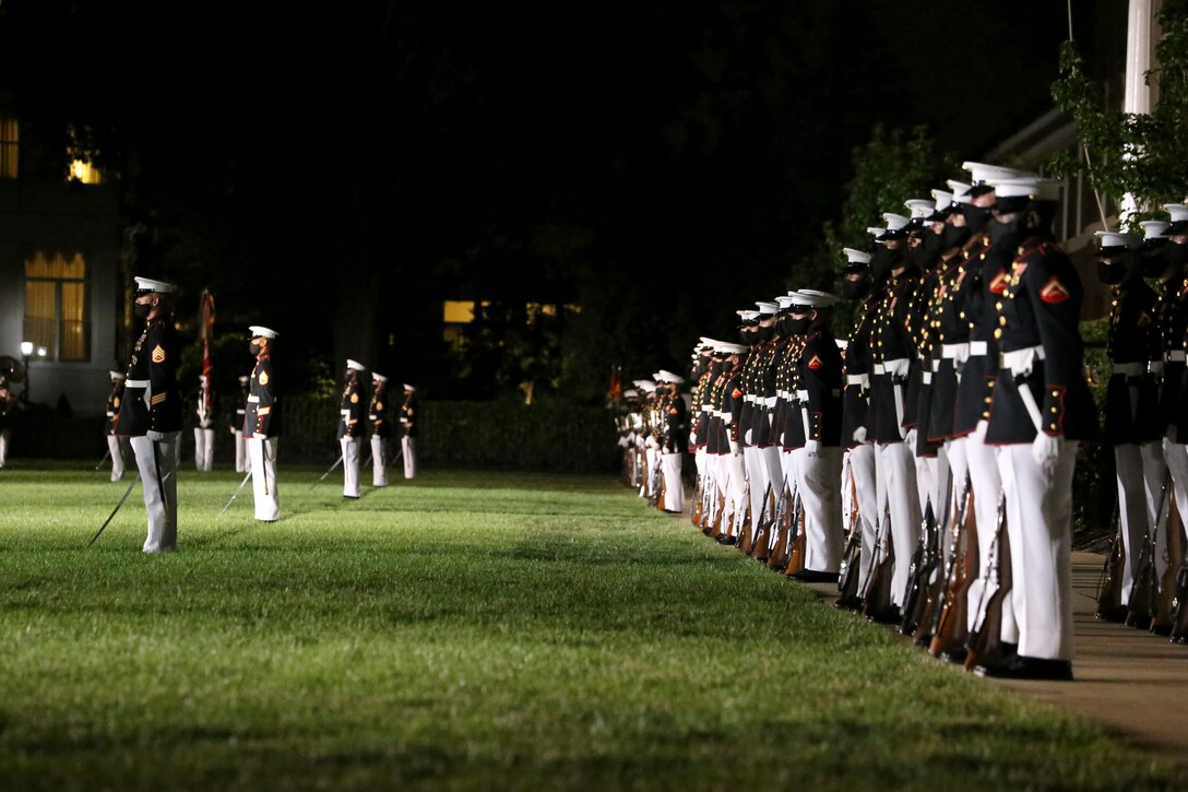 Marines with Alpha and Bravo Marching Companies stand at the position of attention during the Staff Noncommissioned Officer Friday Evening Parade at Marine Barracks Washington, D.C., Aug. 7, 2020. Staff Noncommissioned Officers took charge and filled key leaders’ roles and billets throughout the parade. The 19th Sergeant Major of the Marine Corps, Sgt. Maj. Troy E. Black, hosted last night’s ceremony, and the guest of honor was the Senior Enlisted Advisor to the Chairman of the Joint Chiefs of Staff, Ramón “CZ” Colón-López. (U.S. Marine Corps photo by Lance Cpl. Allen Sanders)