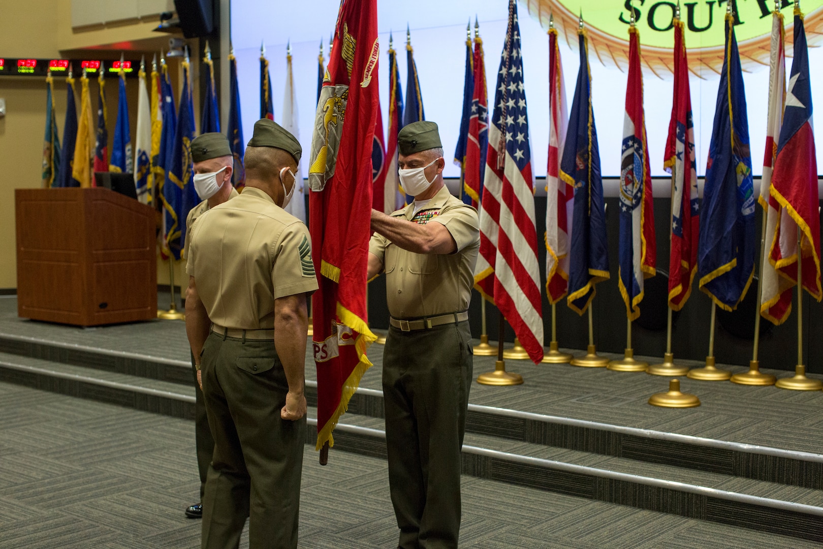 U.S. Marines hold a flag.