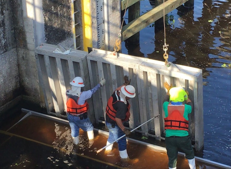 The crew moves the second needle, still suspended from the crane, close to the girder. A diver also checks to be sure the needle has been properly placed.