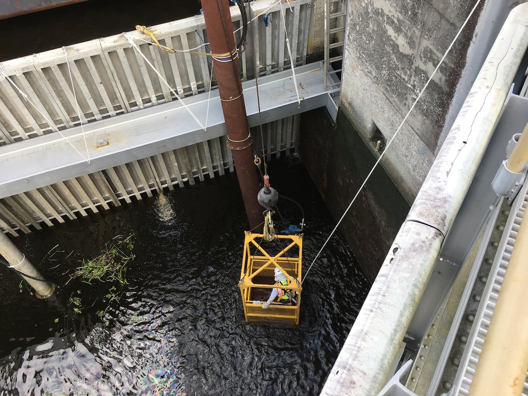 Once the water level has gone down, a 4 Man Basket is used to lower the crew into the chamber so they can remove vegetation and lift native fish up and out of the chamber.