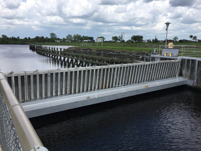 The needles have been set in place in the needle slot in the bottom of the lock chamber and secured to the I-beam girder across the end of the lock chamber, the first step in isolating the lock chamber so it can be dewatered.