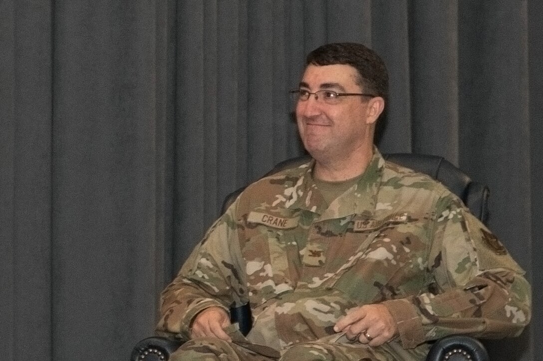 Airman smiling at ceremony.