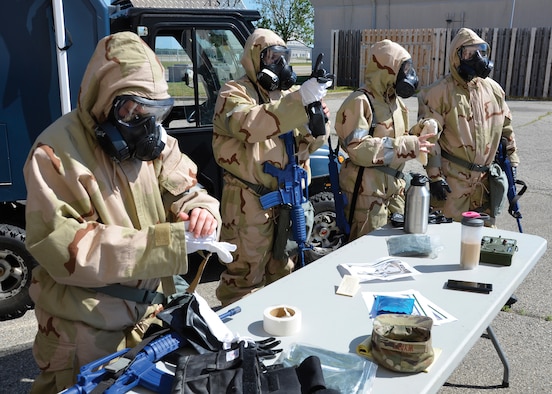Airmen with the 445th Civil Engineer Squadron’s readiness and emergency management flight, remove their protective equipment after completing their training Wright-Patterson Air Force Base, Ohio June 25, 2020. The training saw Airmen plan out routes and determine the best locations to place indicators of airborne threats while maintaining an alert and defensive posture, requiring them to wear Mission Oriented Protective Posture (MOPP) gear. (U.S. Air Force photo/Staff Sgt. Ethan Spickler)
