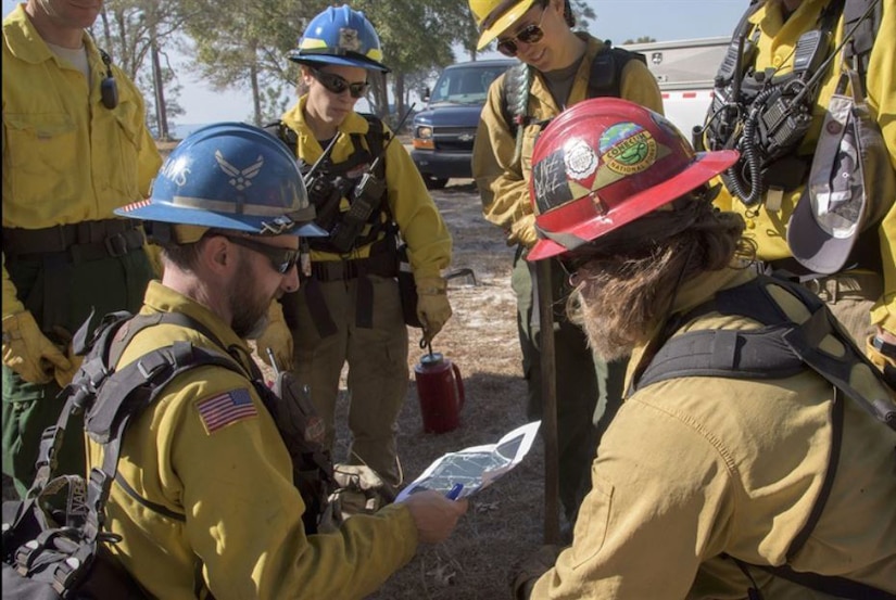 Firefighters look at a map.
