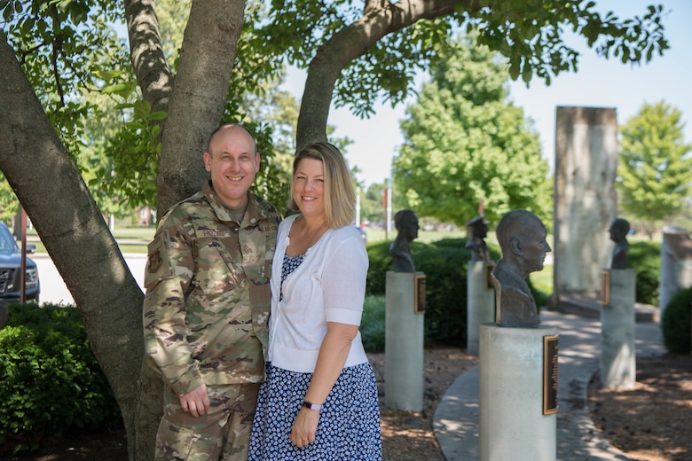 Family photo of Chief Frizzell and his wife Kerri outside of the 375th AMW wing HQ.