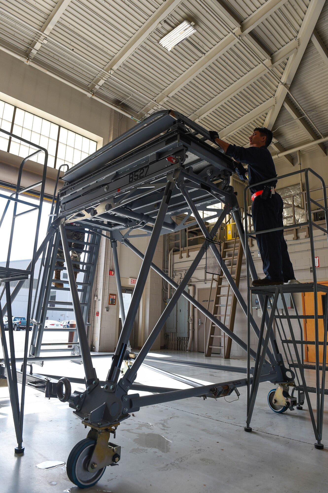 Senior Airman Christian Inscoe, 62nd Maintenance Squadron aerospace ground equipment (AGE) journeyman, works on securing a stand to prepare it for loading onto an aircraft on Joint Base Lewis-McChord, Wash., Aug. 3, 2020. Stands are typically used by maintenance personnel to inspect aircraft engines and other parts on a plane that are high up. (U.S. Air Force photo by Airman 1st Class Mikayla Heineck)