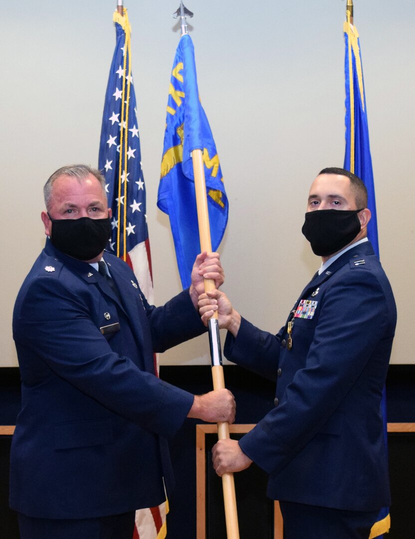 Lt. Col. Stuart Martin (left), 433rd Maintenance Group commander, presents the guidon to Capt. Nicholas Velazquez, 433rd Maintenance Squadron commander, at an assumption of command ceremony at Joint Base San Antonio-Lackland Aug. 8. Prior to earning a commission, Velazquez was an enlisted master sergeant in the maintenance career field.