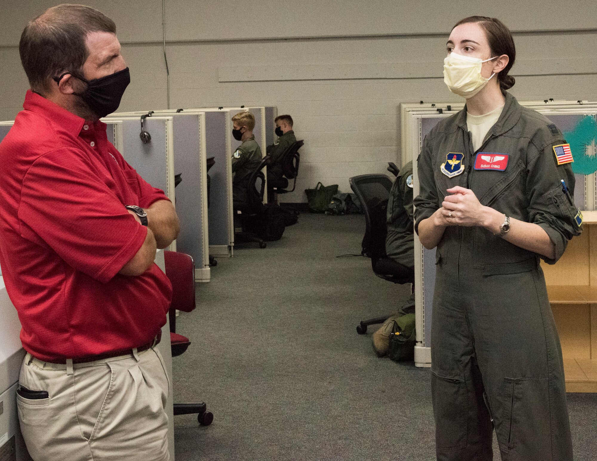 Cap. Susan Ching, 47th Flying Training Wing public health and emergency officer, explains possible measures to prevent COVID-19 in the simulation building to Jim DeReus, 47th Operations Group T-6 lead civilian simulator instructor, at Laughlin Air Force Base, Texas, Aug. 5, 2020. The Center for Disease Control says taking these precautions are the best way to prevent catching COVID-19, and, not only are these methods good for preventing the virus, but also other forms of infectious diseases and keeping the workplace safe. (U.S. Air Force Photo by Airman 1st Class David Phaff)