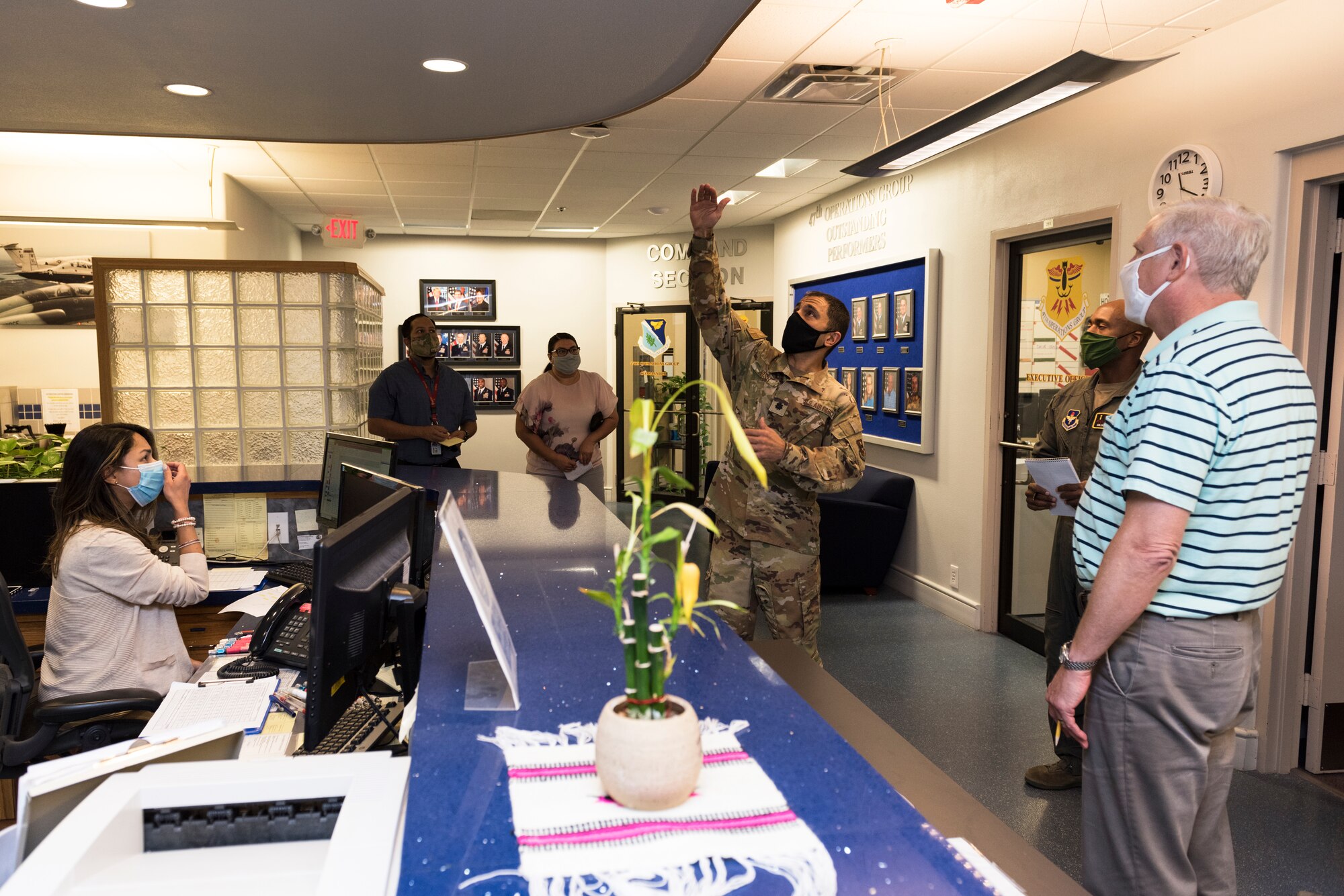 Lt. Col. Hafez Nasr, 47th Medical Group chief of aerospace medicine, suggests a Plexiglas divider to protect those--such as the dispatcher--who frequently interact with students, Aug. 6, 2020 at Laughlin Air Force Base, Texas. Two 47th MDG public health officers toured the simulation building and suggested better ways to prevent COVID-19. (U.S. Air Force photo by Senior Airman Anne McCready)