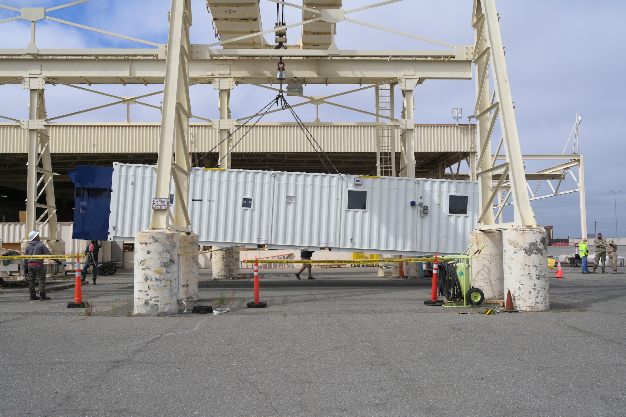 A Negatively Pressurized Conex hangs from a 35-ton fixed bridge crane.
