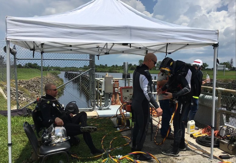 The first step in work phase is to get divers into the water to clear and clean the needle slots, which are under the water on the bottom of the lock chamber. Needles, which look like metal panels, will be installed into the needle slots. The needle system serves as a temporary “cofferdam” to isolate a part of the structure for dewatering.