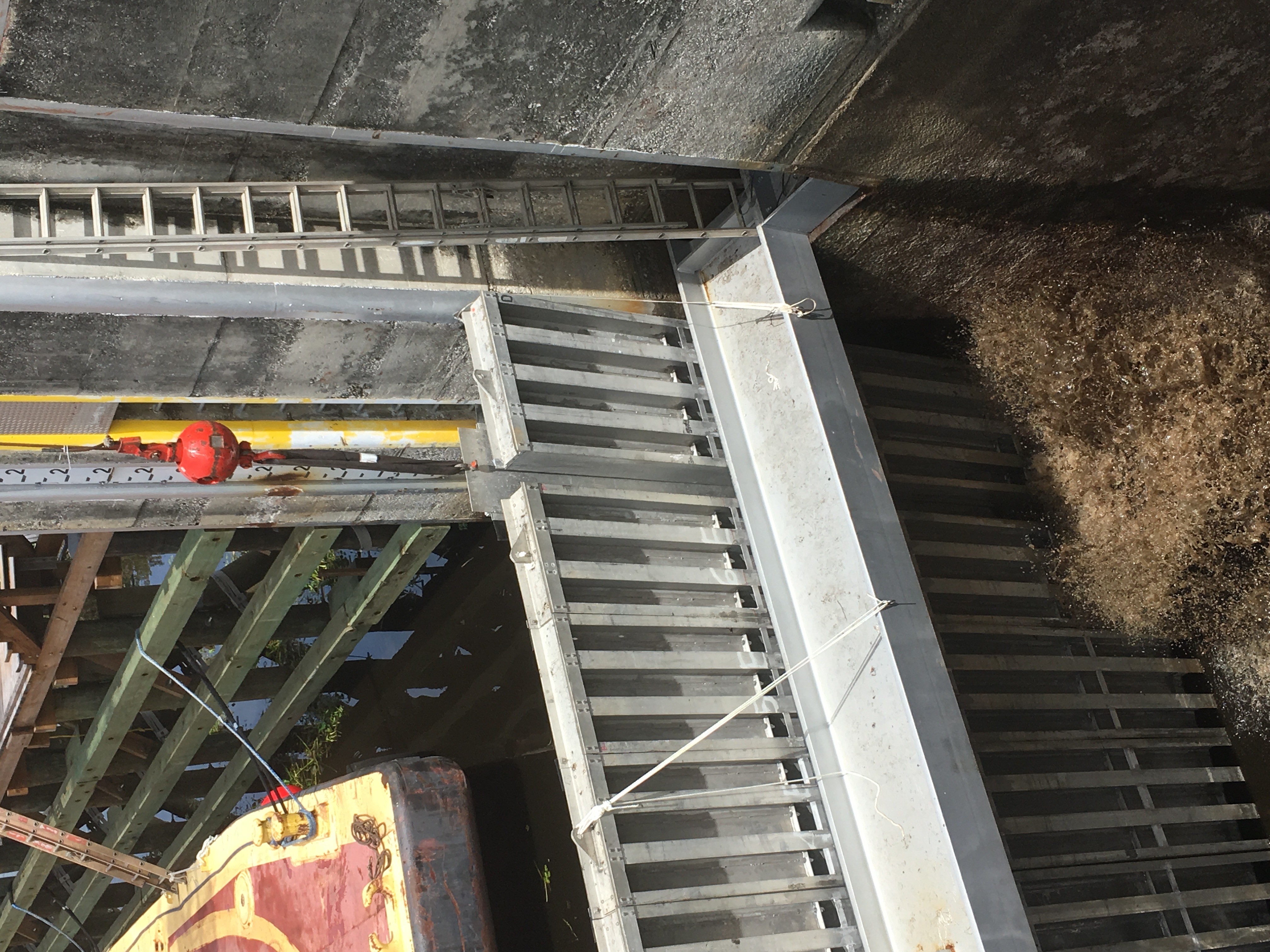 The crane operator starts to lift the slide plate, instantly relieving