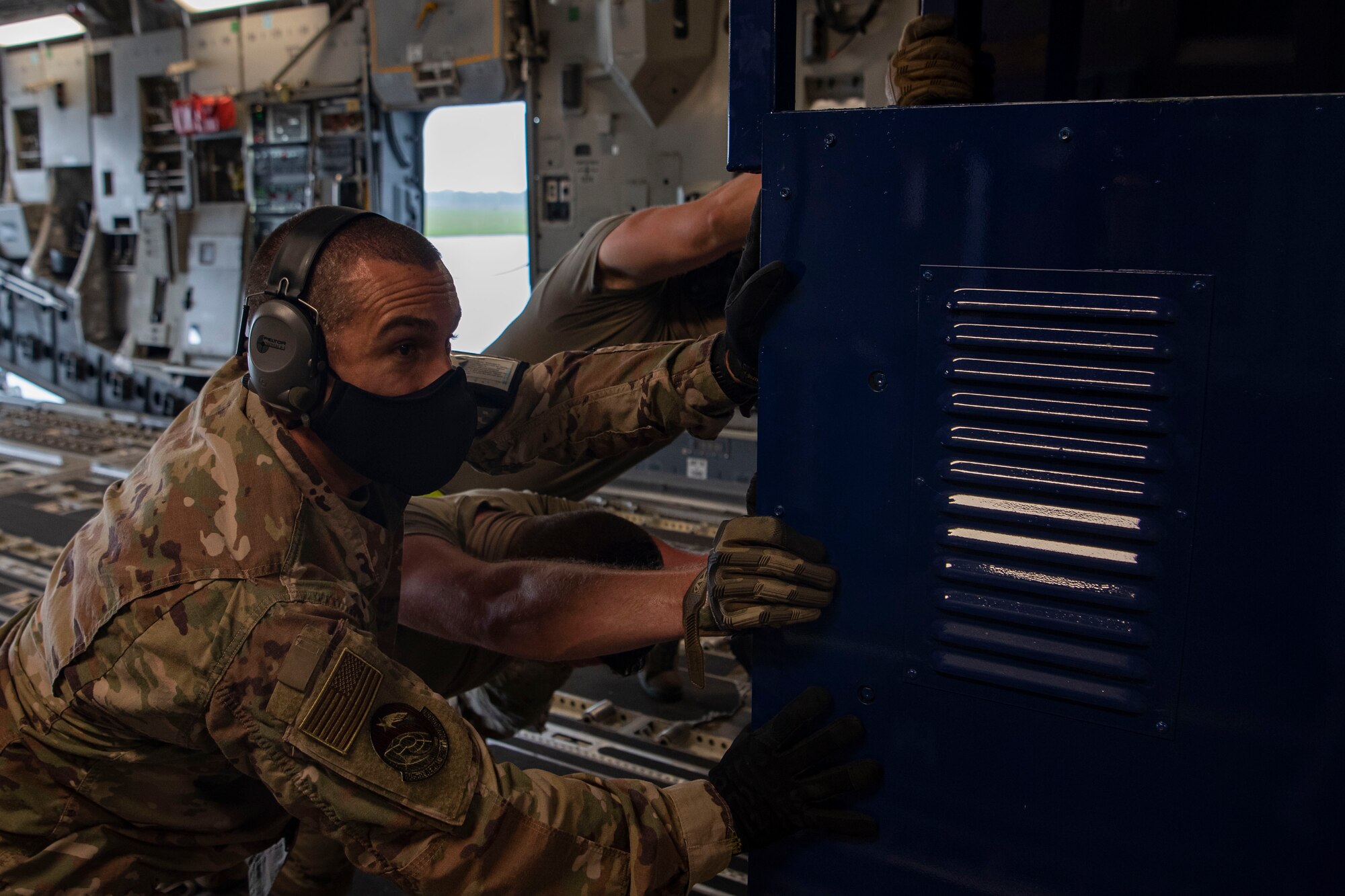 The 305th Air Mobility Wing plays a role in the fight against COVID-19 by delivering the latest isolated containment chamber developed for high-capacity transport of patients.