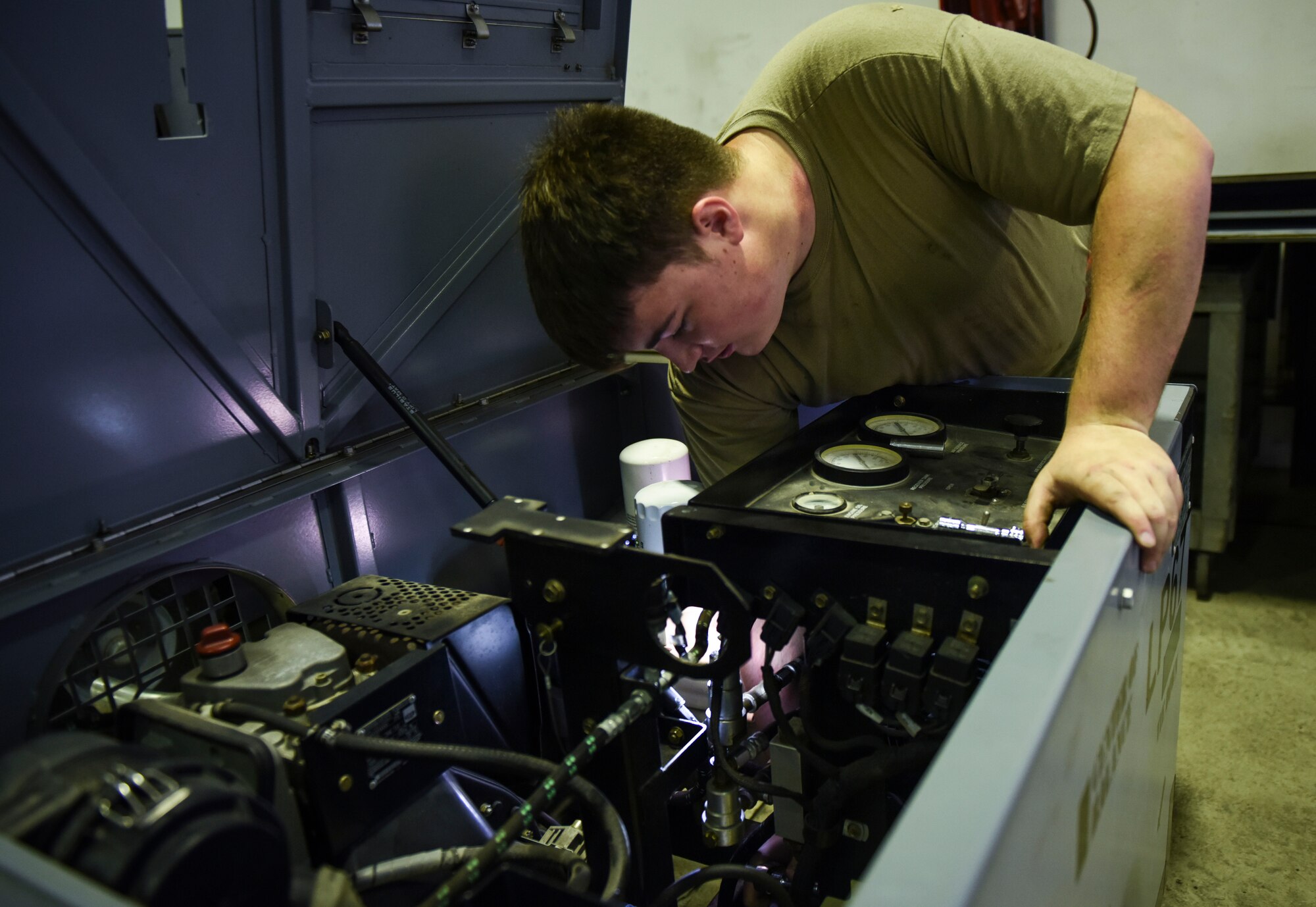 Maintainer Airman testing mechanical equipment