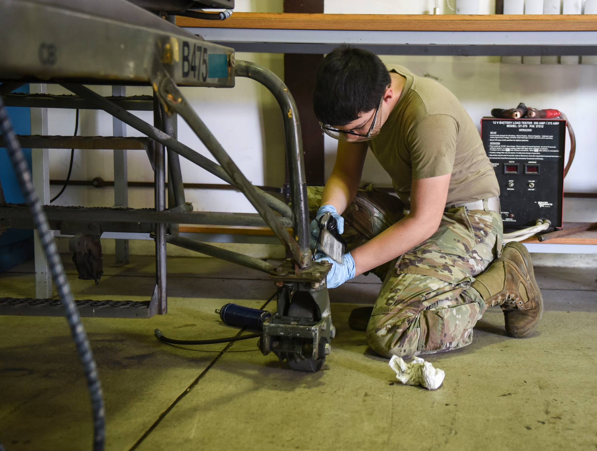 Maintainer Airman fixing a piece of equipment