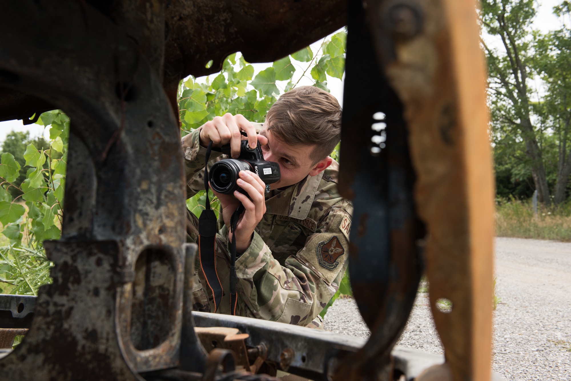 U.S. Air Force Tech. Sgt. Chase Bevill, 509th Bomb Wing safety specialist, takes a photo of a vehicle mishap at Whiteman Air Force Base, Missouri, on July 14, 2020. Safety specialists take investigative photos to assist with determining how the mishap occurred. (U.S. Air Force photo by Airman 1st Class Christina Carter)