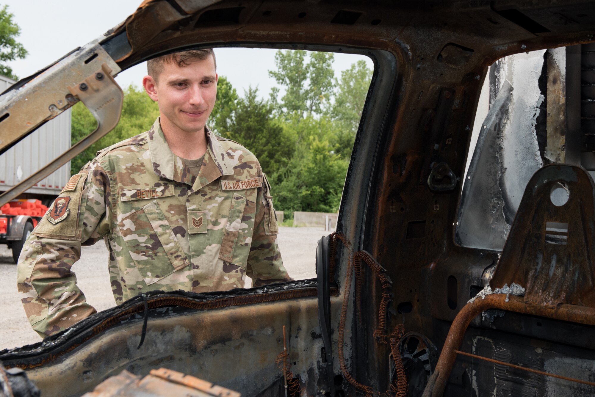 U.S. Air Force Tech. Sgt. Chase Bevill, 509th Bomb Wing safety specialist, inspects a vehicle mishap at Whiteman Air Force Base, Missouri, on July 14, 2020. Safety specialists deal with investigating mishaps that occur on base and sometimes off base. (U.S. Air Force photo by Airman 1st Class Christina Carter)