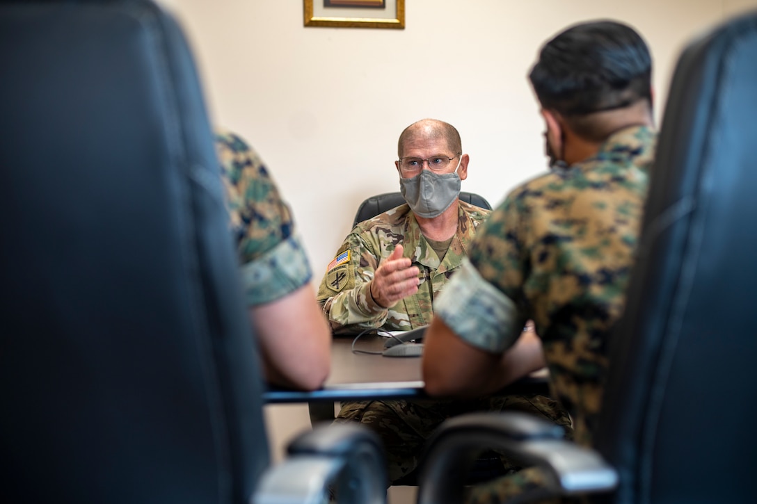 U.S. Army Maj. Derek Butler, a civil liaison officer with Joint Task Force – Bravo, speaks with U.S. Marine Corps civil affairs specialists with Special Purpose Marine Air-Ground Task Force - Southern Command about civil affairs missions at Soto Cano Air Base, Honduras, Aug. 6, 2020. A group of approximately 20 Marines from the SPMAGTF-SC has joined with Joint Task Force - Bravo in support of operations and exercises in the Latin American and Caribbean region. The remainder of the task force is prepared to deploy to the region to work alongside partner nation militaries, enhancing combined crisis response efforts in the U.S. Southern Command area of responsibility. Butler is a native of Houston, Texas. (U.S. Marine Corps photo by Sgt. Andy O. Martinez)