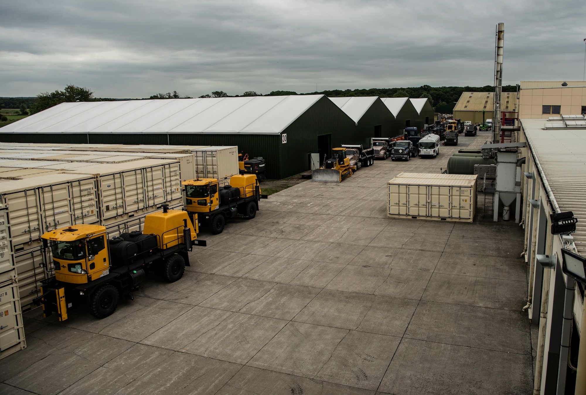 The green buildings house the extra heavy machinery occupying the facility.