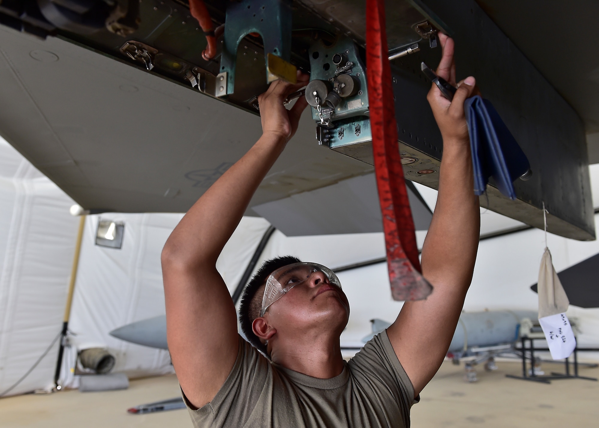 Weapons Airmen remove pylon for routine inspection